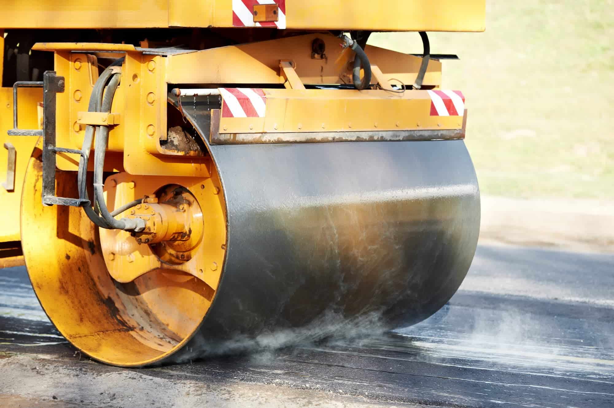 An asphalt paver truck paving hot asphlat.